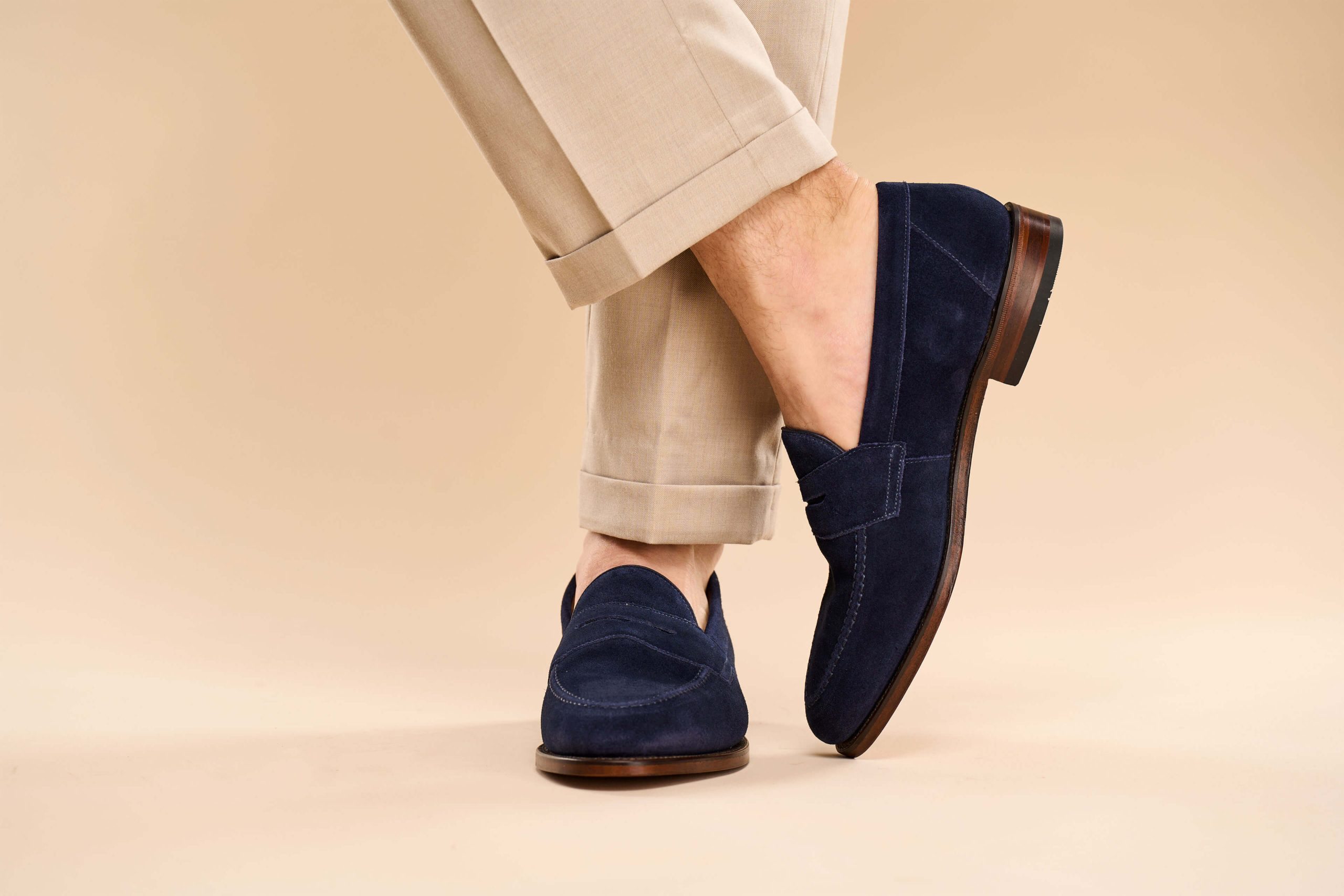 Loake Imperial Navy Loafers with beige trousers.